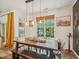 Bright dining room featuring a rustic table, bench seating, and modern light fixtures at 903 Grace Point Rd, Morrisville, NC 27560