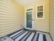 Inviting front porch with a striped rug, perfect for welcoming guests to your new home at 903 Grace Point Rd, Morrisville, NC 27560