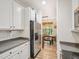 Modern kitchen with stainless steel appliances and view into dining area at 903 Grace Point Rd, Morrisville, NC 27560