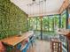 Inviting screened patio with dining area, wood table, stylish chairs and a view of the lake at 903 Grace Point Rd, Morrisville, NC 27560