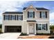 Charming two-story home with a modern design, open garage, and neutral siding at 102 Winterberry Dr, Sanford, NC 27330