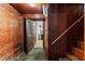 Basement featuring wood-paneled walls and brick accents, providing a unique and rustic aesthetic for various uses at 1100 Brooks Ave, Raleigh, NC 27607