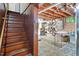 Spacious basement featuring exposed brick walls, wooden stairs, and ample storage space, offering potential for customization at 1100 Brooks Ave, Raleigh, NC 27607