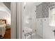Modern bathroom with a stylish shower and geometric patterned accent wall, offering a sleek and functional design at 1100 Brooks Ave, Raleigh, NC 27607