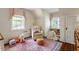 Charming Bedroom featuring a cozy chair, soft rug, and plenty of natural light, perfect for relaxation and play at 1100 Brooks Ave, Raleigh, NC 27607