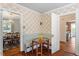 Charming breakfast nook featuring built-in seating, a glass table, and decorative wallpaper at 1100 Brooks Ave, Raleigh, NC 27607