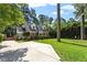 Charming brick home with a well-manicured lawn and a spacious concrete driveway and beautiful landscaping at 1100 Brooks Ave, Raleigh, NC 27607