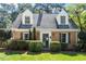 Inviting brick home with shuttered windows, manicured landscaping, and a charming entrance at 1100 Brooks Ave, Raleigh, NC 27607
