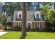 Charming brick home with a well-maintained lawn and mature trees at 1100 Brooks Ave, Raleigh, NC 27607