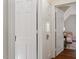 Hallway featuring white doors and trim, providing access to various rooms and spaces in the home at 1100 Brooks Ave, Raleigh, NC 27607