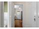 Hallway view of a kitchen with stainless steel refrigerator, light fixtures and patterned wallpaper at 1100 Brooks Ave, Raleigh, NC 27607