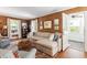 Inviting living room with a fireplace, plush seating, and views to an outdoor living space at 1100 Brooks Ave, Raleigh, NC 27607