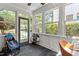 Bright sunroom with tile flooring, large windows, and a view of the lush outdoor scenery at 1100 Brooks Ave, Raleigh, NC 27607