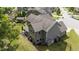 Aerial side view of house showing manicured lawn, back patio, and screened-in porch at 112 Pearsall Farm Ln, Clayton, NC 27527