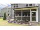Backyard with outdoor kitchen, manicured landscaping, and a screened-in porch at 112 Pearsall Farm Ln, Clayton, NC 27527