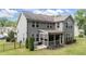 Rear exterior view shows backyard kitchen, landscaping, screened in porch, and fencing at 112 Pearsall Farm Ln, Clayton, NC 27527