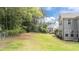 Large grassy backyard, partially fenced and lined with mature trees offers lots of space for outdoor activities at 112 Pearsall Farm Ln, Clayton, NC 27527