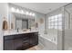 Bright bathroom featuring a double vanity, soaking tub, and glass-enclosed shower at 112 Pearsall Farm Ln, Clayton, NC 27527