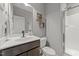 Neutral bathroom features a glass shower door, dark vanity, and tiled flooring at 112 Pearsall Farm Ln, Clayton, NC 27527