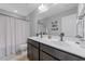 Stylish bathroom with a double vanity, neutral decor, and well-lit mirror at 112 Pearsall Farm Ln, Clayton, NC 27527