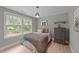 Charming bedroom with wood floors, picture window, and nature-themed decor at 112 Pearsall Farm Ln, Clayton, NC 27527