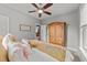 Cozy bedroom with neutral walls and view into ensuite, featuring natural-colored dresser at 112 Pearsall Farm Ln, Clayton, NC 27527