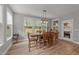 Bright dining room with a rustic table, natural light, and views of the backyard at 112 Pearsall Farm Ln, Clayton, NC 27527