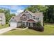 Charming two-story home featuring a lush lawn, colorful landscaping, and a welcoming entrance at 112 Pearsall Farm Ln, Clayton, NC 27527