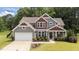 Charming two-story home with a well-manicured lawn, beautiful landscaping, and a welcoming front porch at 112 Pearsall Farm Ln, Clayton, NC 27527