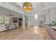 Open foyer with a view into the living room, fireplace, staircase, and beautiful light fixtures at 112 Pearsall Farm Ln, Clayton, NC 27527