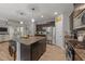 Spacious kitchen featuring a large island with seating, stainless appliances, and wood floors at 112 Pearsall Farm Ln, Clayton, NC 27527