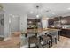Spacious kitchen featuring a large island with seating, granite countertops, and dark wood cabinetry at 112 Pearsall Farm Ln, Clayton, NC 27527