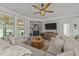 Inviting living room features a stone fireplace, wood flooring, and comfortable neutral sectional seating at 112 Pearsall Farm Ln, Clayton, NC 27527