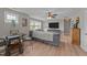Comfortable living area with gray sofa, flat screen television, and natural lighting at 112 Pearsall Farm Ln, Clayton, NC 27527
