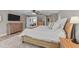 Cozy bedroom with wood flooring, a ceiling fan, and a view into the living room at 112 Pearsall Farm Ln, Clayton, NC 27527