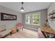 Well-lit office space with a cozy chair, desk, and view of the outdoors at 112 Pearsall Farm Ln, Clayton, NC 27527