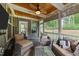 Screened porch features a stained ceiling with ceiling fan, and wicker furniture at 112 Pearsall Farm Ln, Clayton, NC 27527