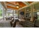 Screened porch with wicker furniture, stained ceiling with fan, and an outdoor tv at 112 Pearsall Farm Ln, Clayton, NC 27527