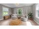 Cozy sitting area with neutral decor, large windows, and comfortable chairs at 112 Pearsall Farm Ln, Clayton, NC 27527