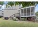 Backyard showing the home's exterior, a screened porch, a deck, and green landscaping at 113 Market Cross Ct, Holly Springs, NC 27540