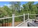 Overlook the wooded backyard from this spacious balcony with plenty of room for outdoor seating at 113 Market Cross Ct, Holly Springs, NC 27540