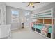 Charming bedroom featuring a bunk bed with built-in storage and sunny windows for natural light at 113 Market Cross Ct, Holly Springs, NC 27540