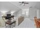 Large bonus room with a ceiling fan, neutral carpet, and a comfortable seating area at 113 Market Cross Ct, Holly Springs, NC 27540