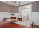 Warm and inviting dining room with hardwood floors and view into the office at 113 Market Cross Ct, Holly Springs, NC 27540
