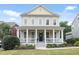 Charming two-story home with a welcoming front porch and well-maintained landscaping at 113 Market Cross Ct, Holly Springs, NC 27540
