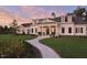 Gorgeous traditional-style home featuring manicured lawn, curved walkway, and elegant facade at 113 Market Cross Ct, Holly Springs, NC 27540