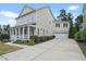 Beautiful home with a long driveway leading to a two-car garage, surrounded by lush landscaping at 113 Market Cross Ct, Holly Springs, NC 27540
