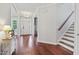 Spacious foyer with wood floors, staircase, and a view of the front door with sidelights at 113 Market Cross Ct, Holly Springs, NC 27540