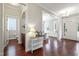 Inviting foyer with beautiful wood floors, showcasing an entry to a powder room and an office at 113 Market Cross Ct, Holly Springs, NC 27540