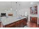 Open-concept kitchen with granite countertops, stainless steel appliances, and a view into the dining area and living room at 113 Market Cross Ct, Holly Springs, NC 27540